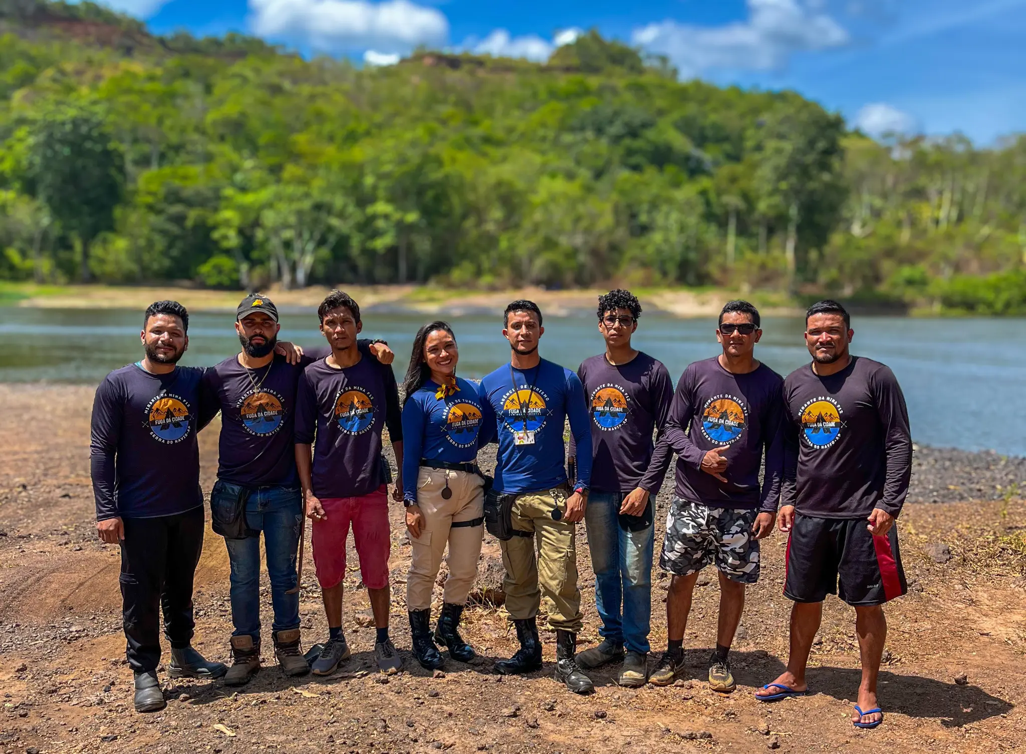 Fuga da Cidade local team standing together beside the Amapari River in Amapá, Brazil